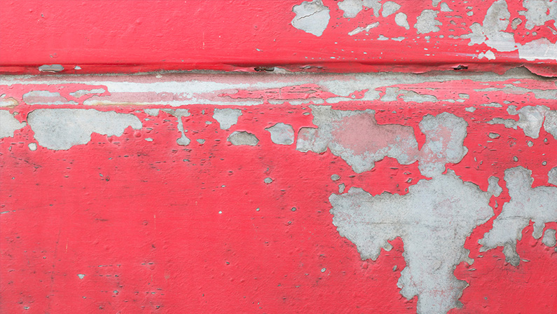 The surface of the red pickup truck car that have its color is peeling and have rust. Old walls, rust-proofing of red cars. Can be used as background texture.