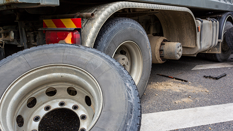 Wheel hub and truck tire in process of changing wheel nut. Maintenance a truck wheels hub and bearing. Rear wheels hub and bolt nut of a truck in process of changing wheel. Brake disc under